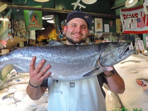 a man holding a large salmon