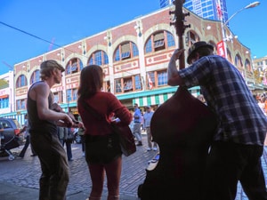 people listening to street musicians - one of the things to do in Seattle