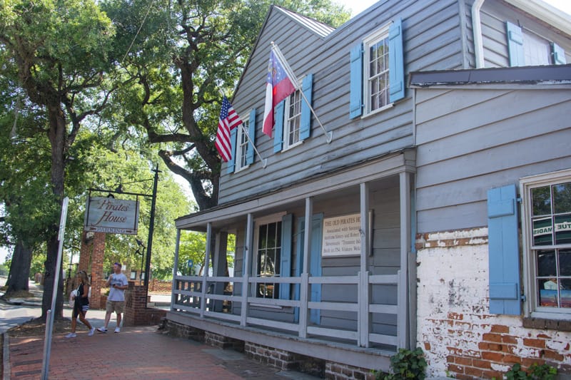 a grey-painted house with blue shutters