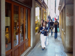 a woman walking down a narrow lane
