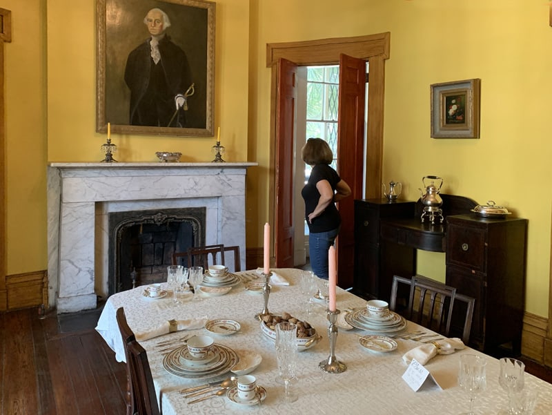 a woman visiting a historical house, one of the things to do in Savannah