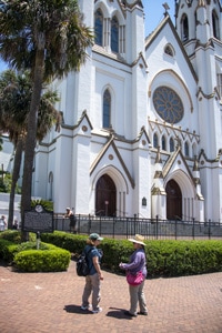 two people in front of a French Gothic church