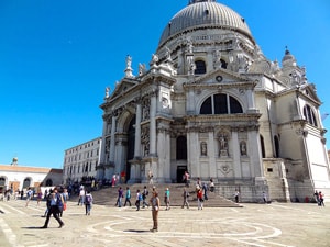 people on a plaza in front of a large domed shurch