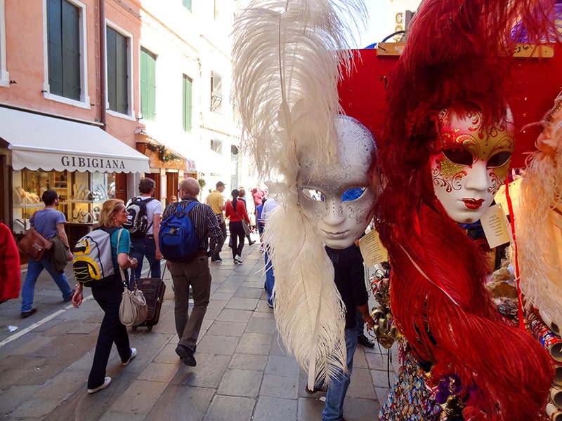 carnevale masks on a shop on a busy pedextrian street