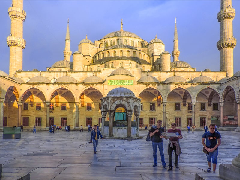 people in the courtyard of a mosque, one of the things to do in Istanbul