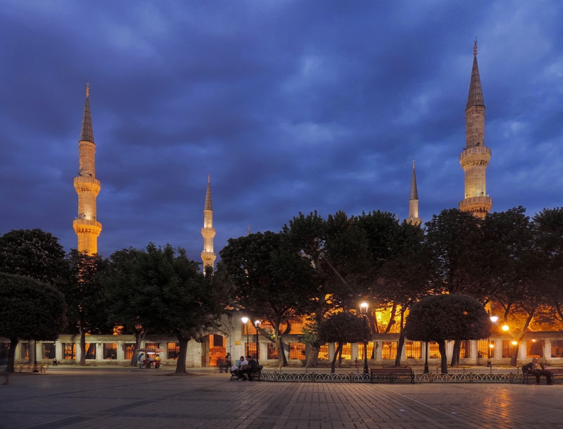 minarets of a mosque illuminated at night