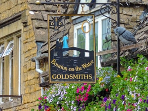 an old shop sign for a goldsmith