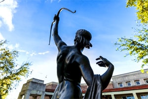 a statue of an archer in one of Florida’s botanical gardens