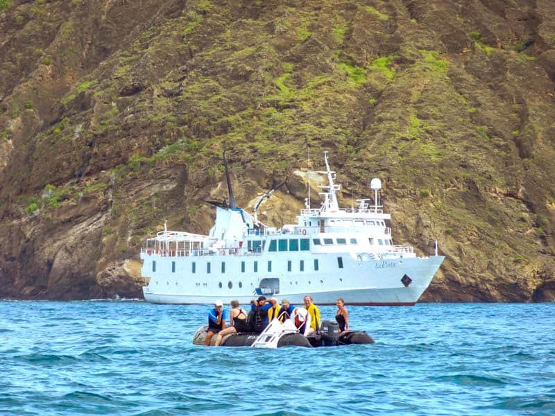 people on a Zodiac going to a ship seen on a Galapagos cruise vacation