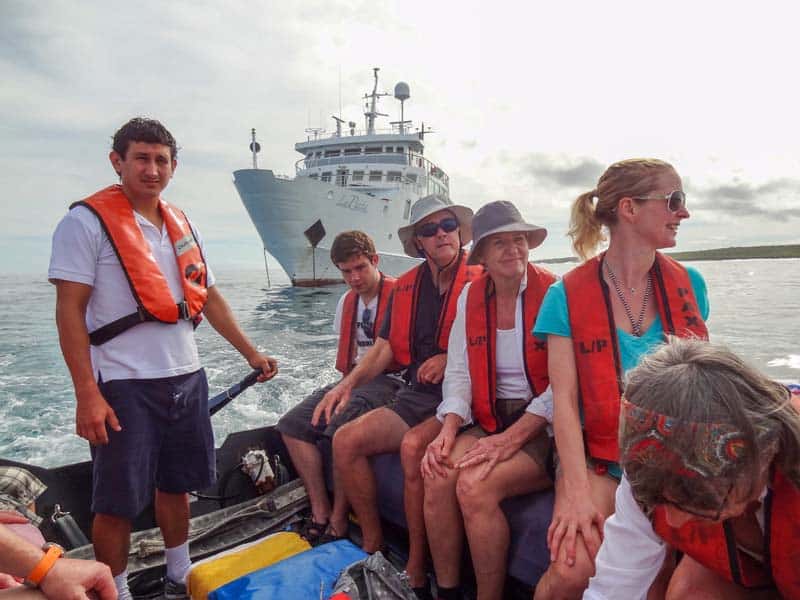 people on a zodiac leaving a ship