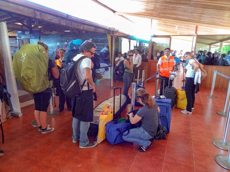 people waiting to go through customs at an airport