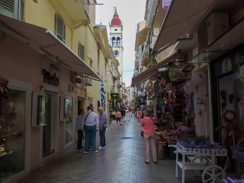 people walking along narrow strret in Old Town - one of the things to do in Corfu