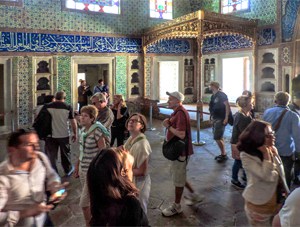 people visiting a room covered with tiles, one of the things to do in Istanbul