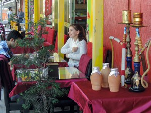 people sitting in a cafe with hookas