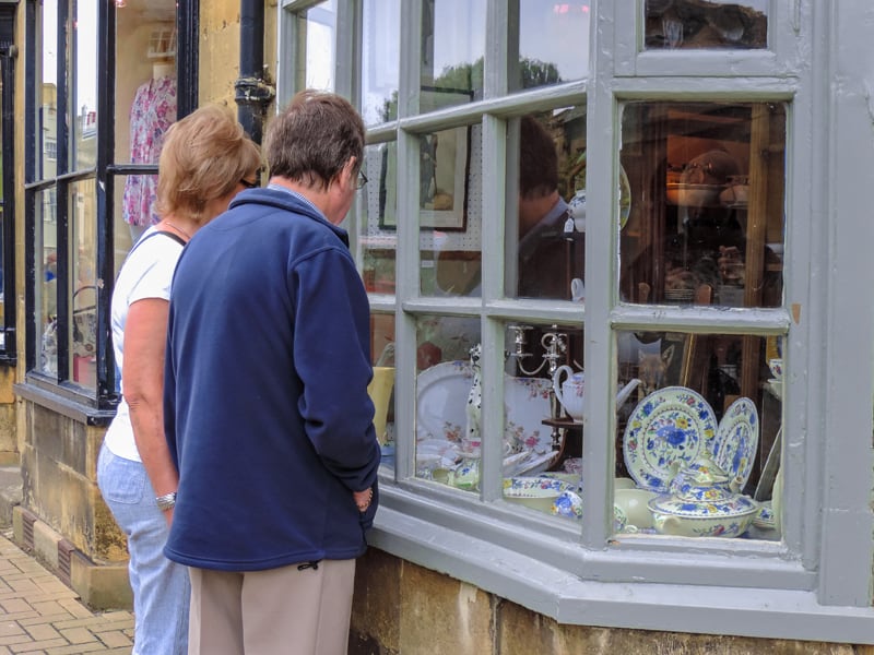 people looking at antiques - one of the things to do in the Cotswolds