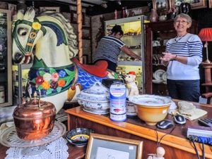 woman in an antiques shop - one of the things to do in the Cotswolds