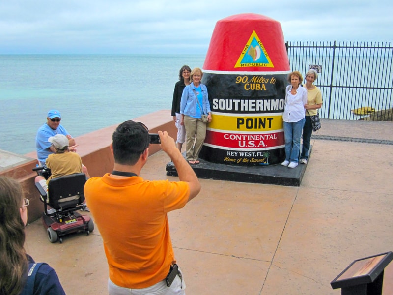 man taking a photo of four women - what to do in Key West