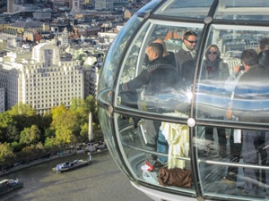 people in a capsule looking at a city