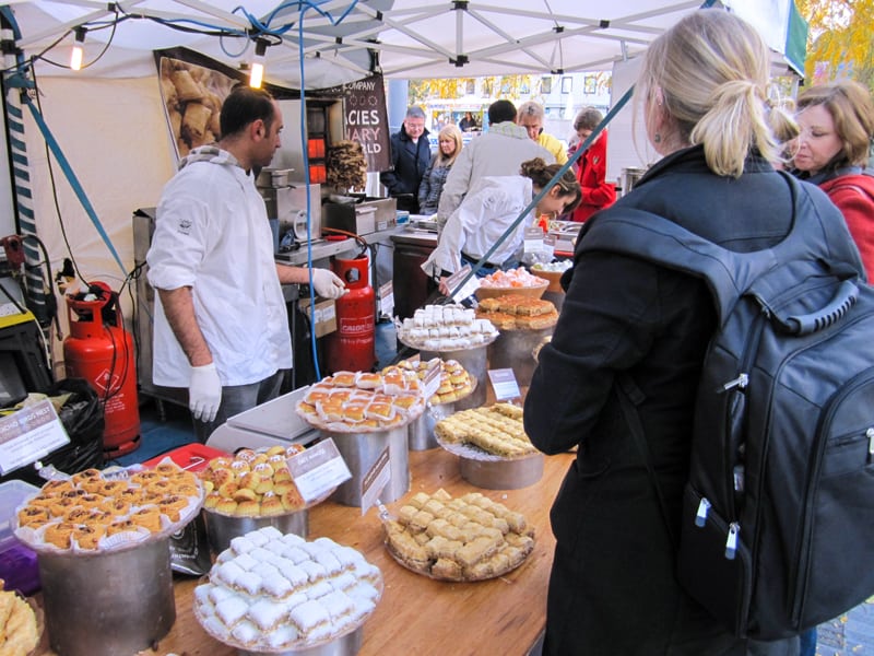 people at a food market, as seen during a walk along the Thames