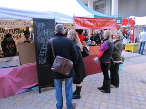 people at a food market, as seen during a walk along the Thames