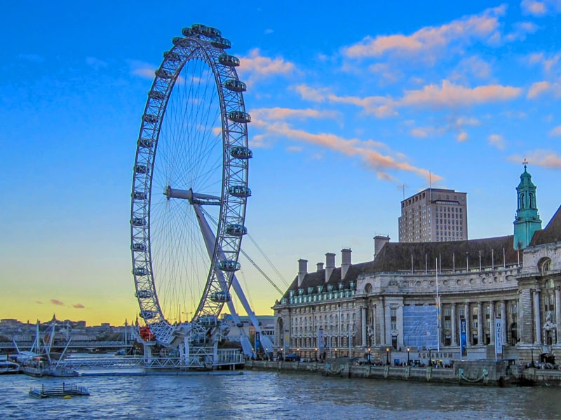 a large Ferris wheel over a waterfront