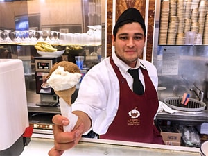 a young man serving ice cream