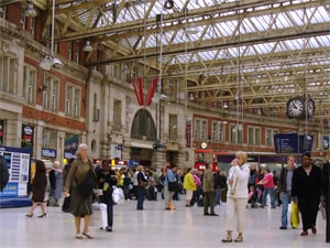 people in a large European train station, as seen during a walk along the Thames