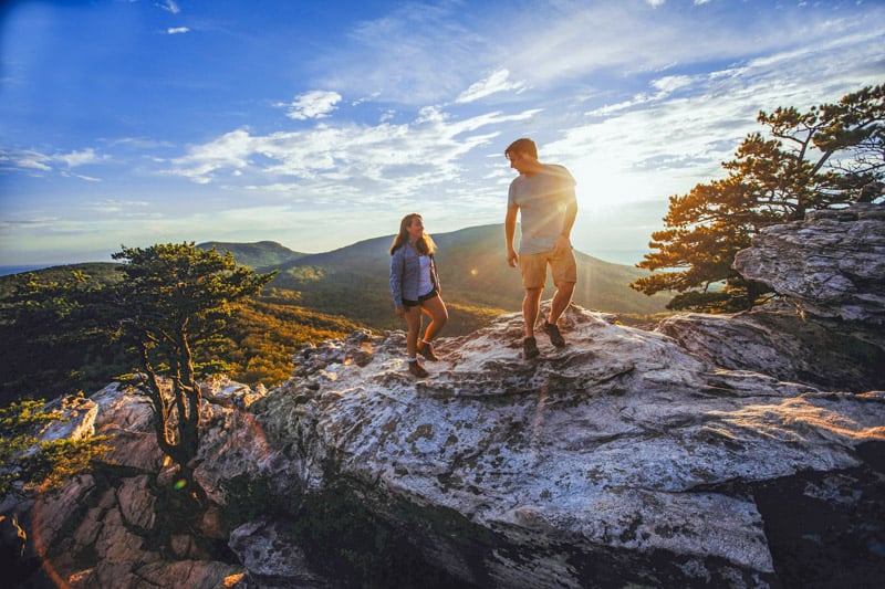 a couple on a rocky outcrop  in the North Carolina High Country at sunset