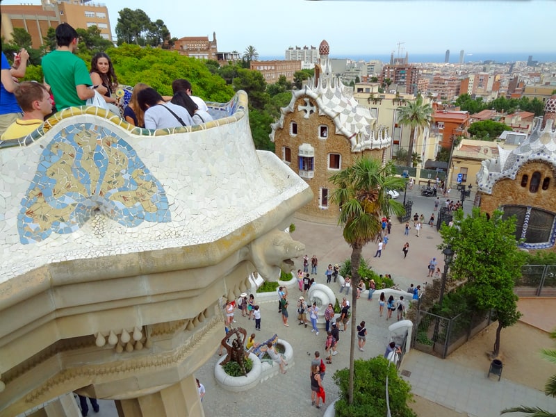 people in a park with fairy-tale-looking buildings