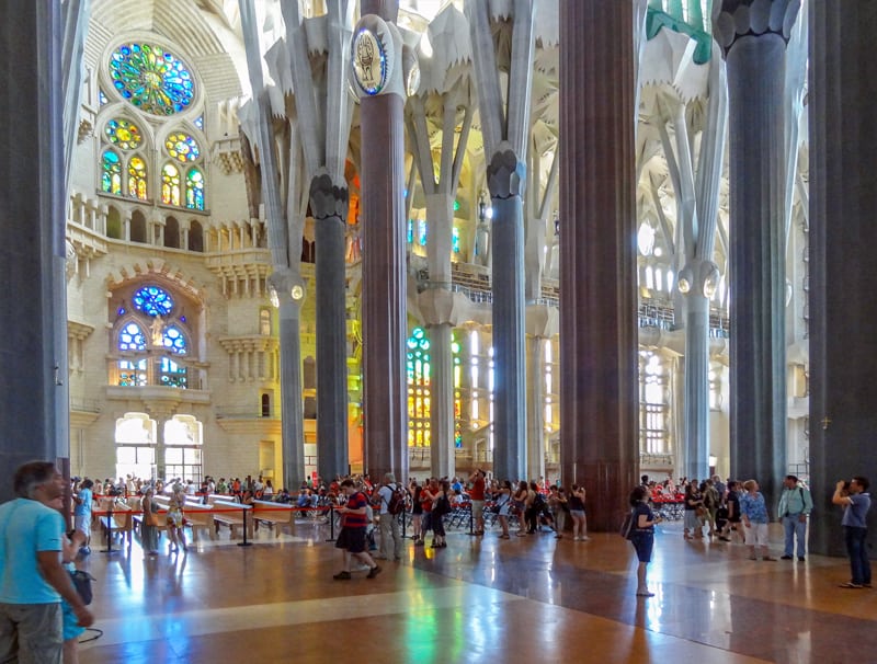 people in a colorful cathedral - one of the Gaudi buildings