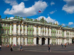 people on a plaza in front of a palace