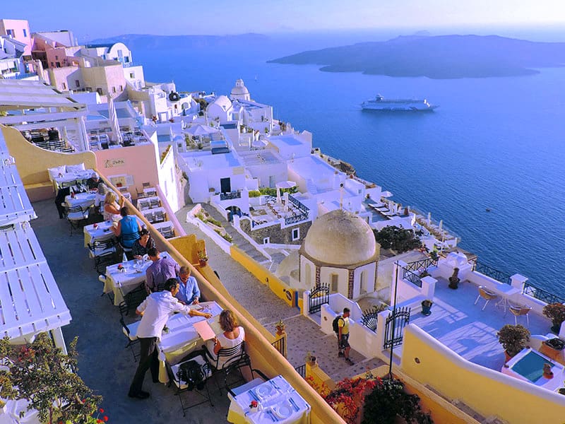 People dining overlook the Aegean Sea - what to do in Santorini