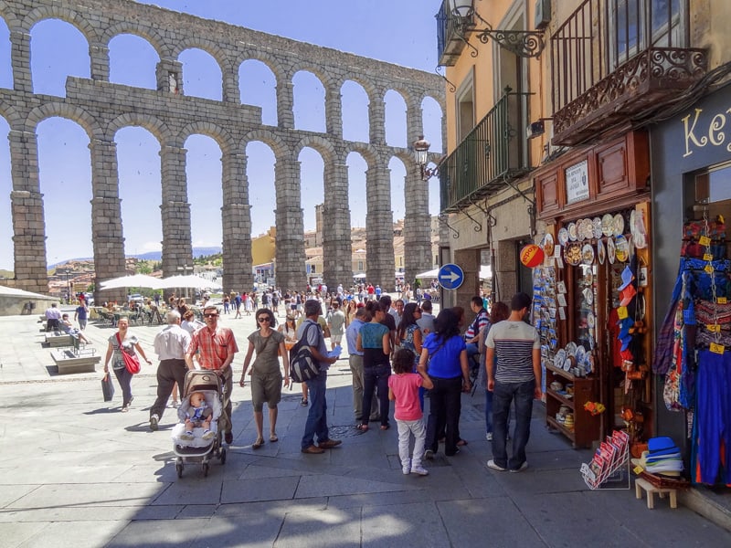 people looking at an ancient Roman aqueduct