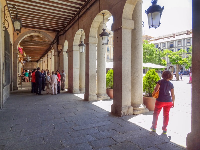 people standing in an old city square