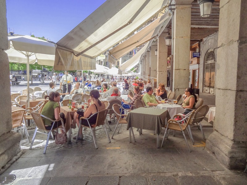 people having lunch in an outdoor restaurant on a day trip to Segovia from Madrid