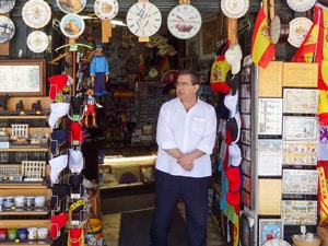 a shopkeeper in the doorway of his shop