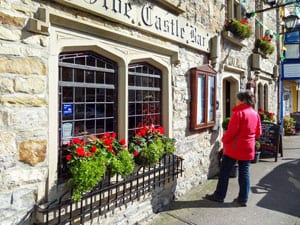 a woman looking at a menu outside a restaurant