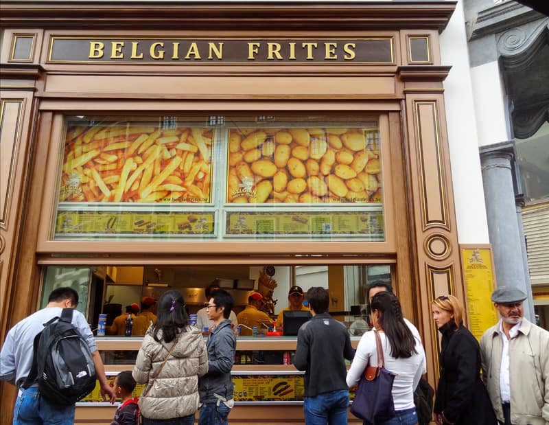 people buying Belgian fries to sample  good Brussels food