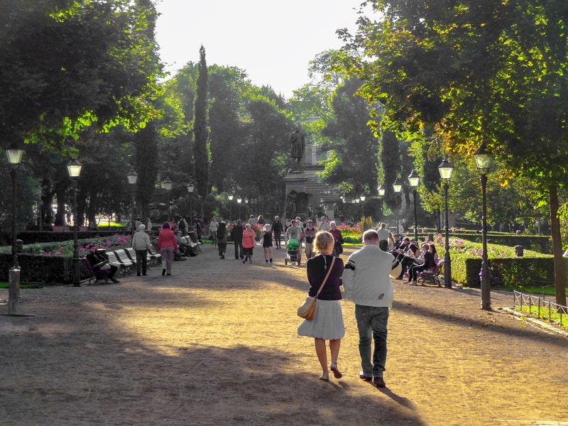 people walking along a broad path in a park, one of the things to do in Helsinki