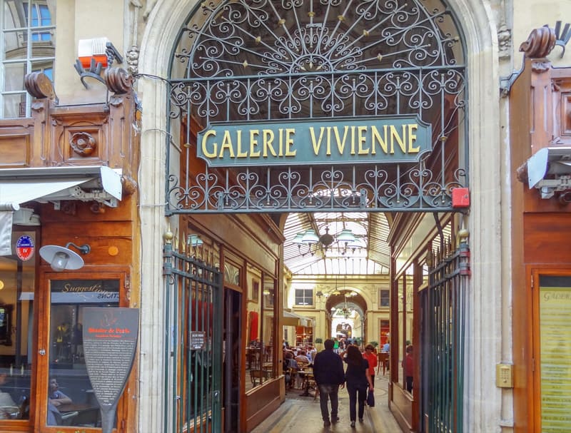 people walking into one of the hidden passages of Paris