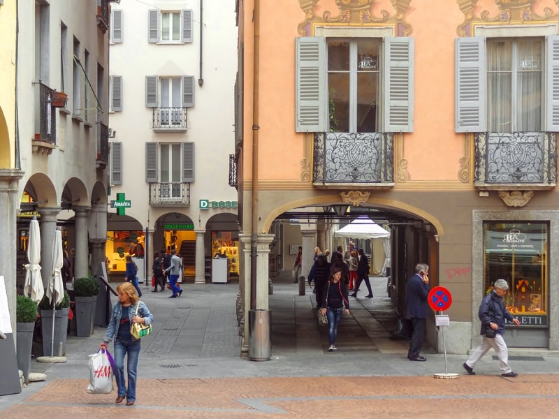 people looking at an arnate old building, one of the things to do in Lugano