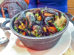 a bucket of mussels in a restaurant