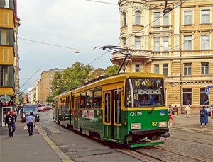 a trolley on a street with beautiful old buildings