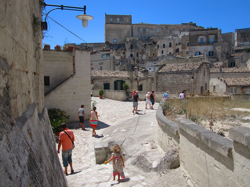 people walking through the ruins in the Sassi in Matera