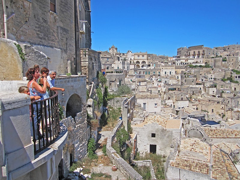 people on a balcony looking at the in the Sassi in Matera