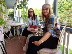 two women enjoying coffee in an outdoor cafe