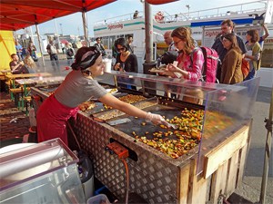 people ordering food at an outdoor market, one of the things to do in Helsinki