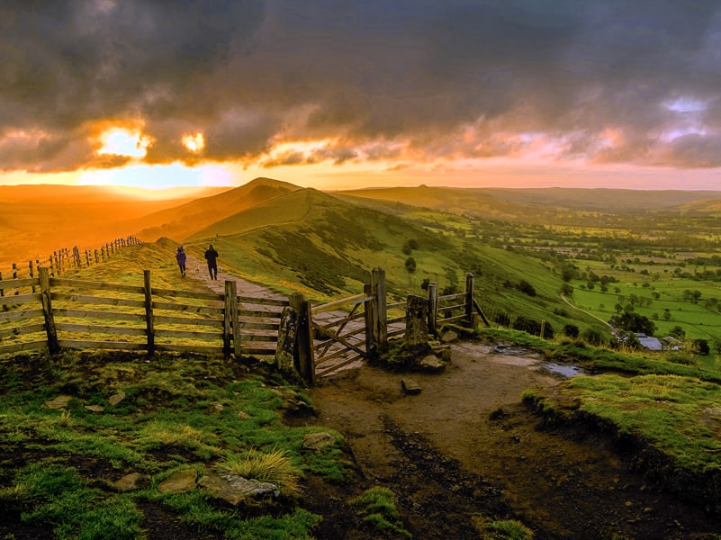 people walking through the hills at sunset in Derbyshire