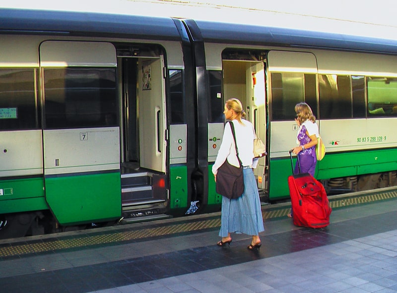 two women getting on a train in Italy