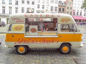 a man in a van selling waffles 